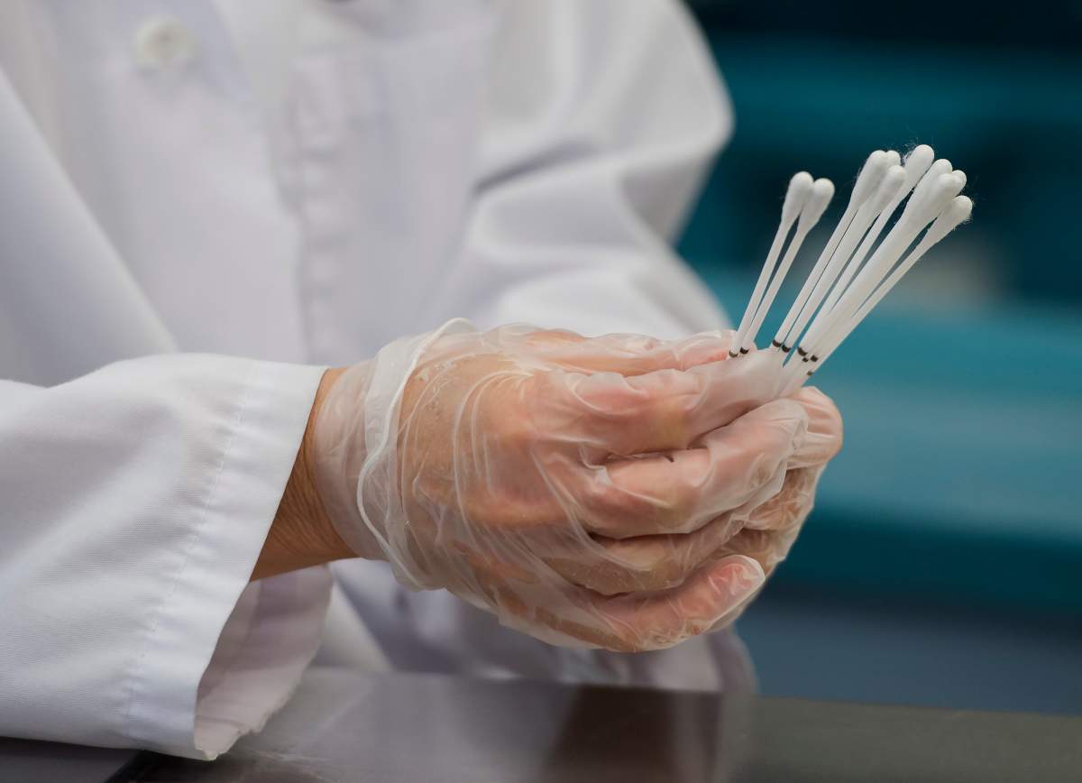 Employees work at the Canadian Hospital Specialities (CHS) helping take dual COVID-19 testing swab kits and separating them into two units to help with swab capacity during the COVID-19 pandemic in Oakville, Ont., on Monday, June 8, 2020. 