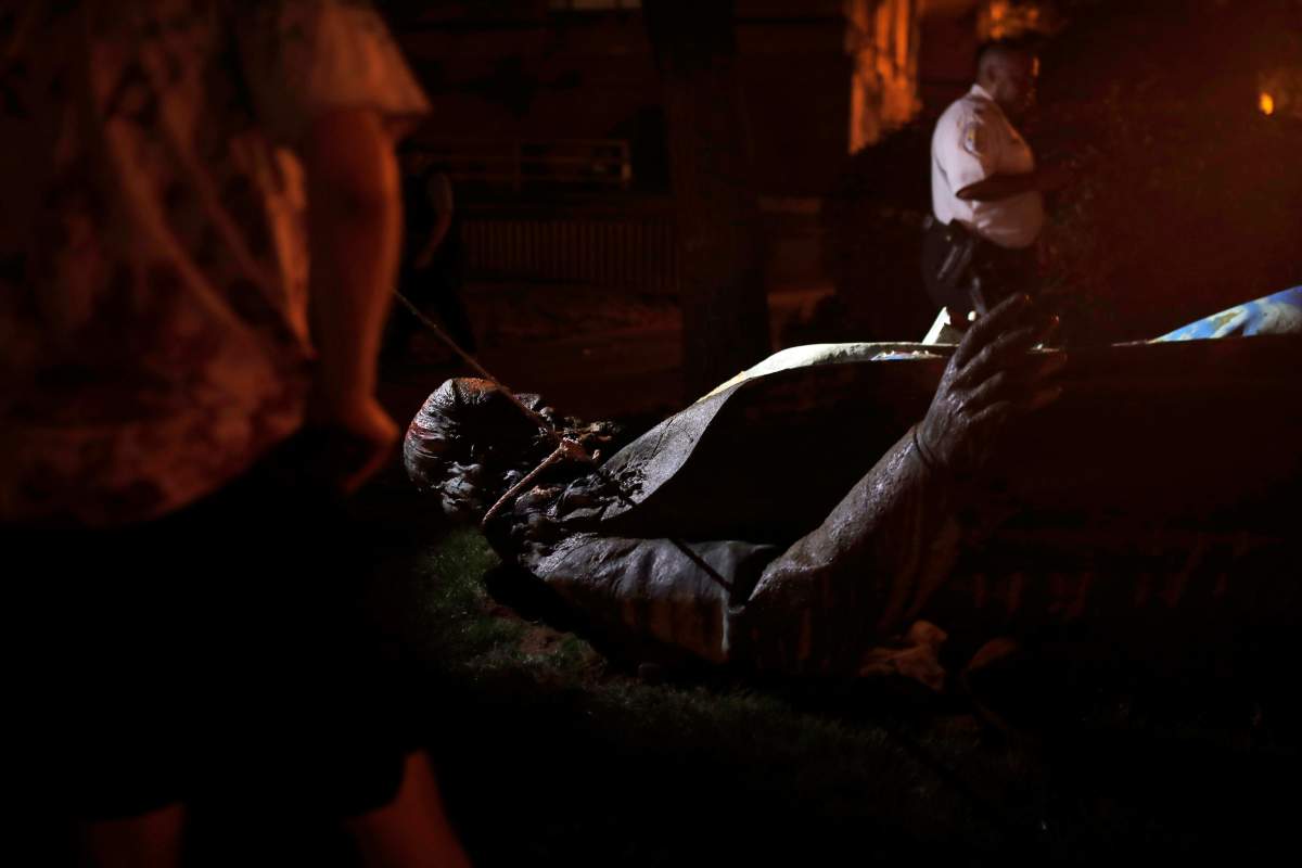The only statue of a Confederate general, Albert Pike, in the nation's capital, lies on the ground after it was toppled by protesters and set on fire in Washington early June 20, 2020.