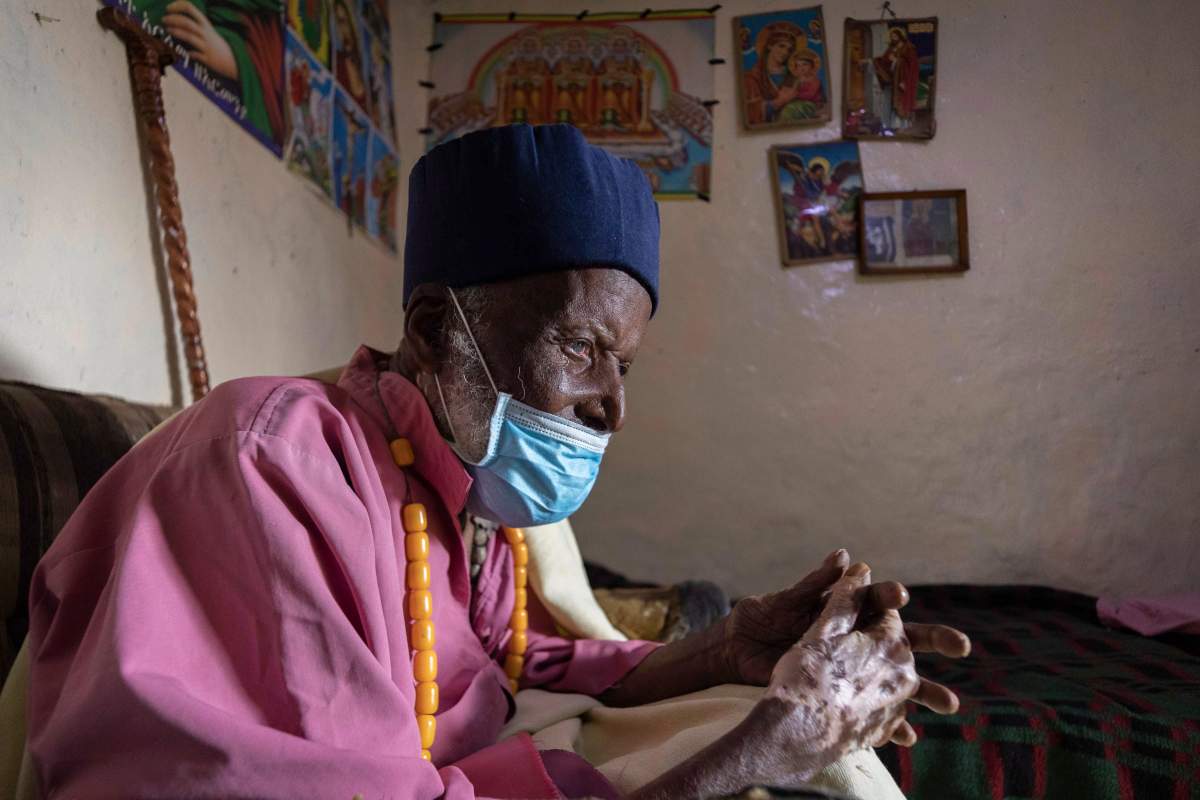 Centenarian Tilahun Woldemichael crys as he prays to God after spending weeks in hospital recovering from the coronavirus, at his house in Addis Ababa, Ethiopia June 27, 2020. Mulugeta Ayene / The Associated Press
