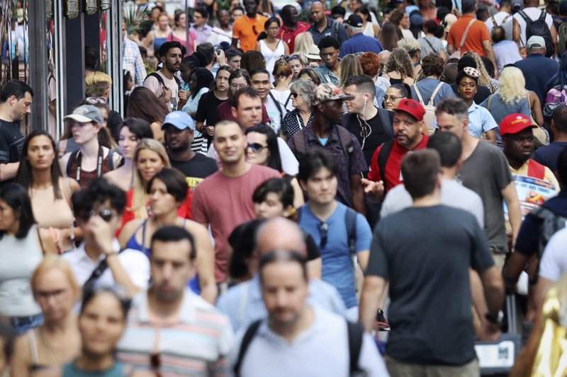 FILE - In this Aug. 22, 2019, file photo, people walk through New York's Times Square. The population of non-Hispanic whites in the U.S. has gotten smaller in the past decade as deaths have surpassed births in this aging demographic, and a majority of the population under age 16 is nonwhite for the first time though they are fewer in number than a decade ago, according to new figures released Thursday, June 25, 2020, by the U.S. Census Bureau. 