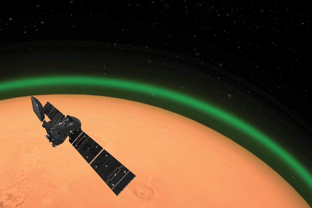An artist’s impression of ESA’s ExoMars Trace Gas Orbiter detecting the green glow of oxygen in the Martian atmosphere.