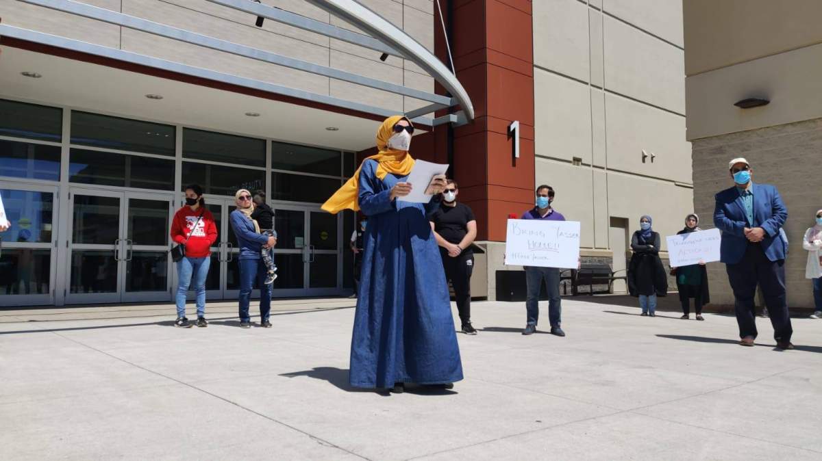 Amal Albaz speaks at a protest in Burlington on June 13 in front of the office of Karina Gould, minister of international development.