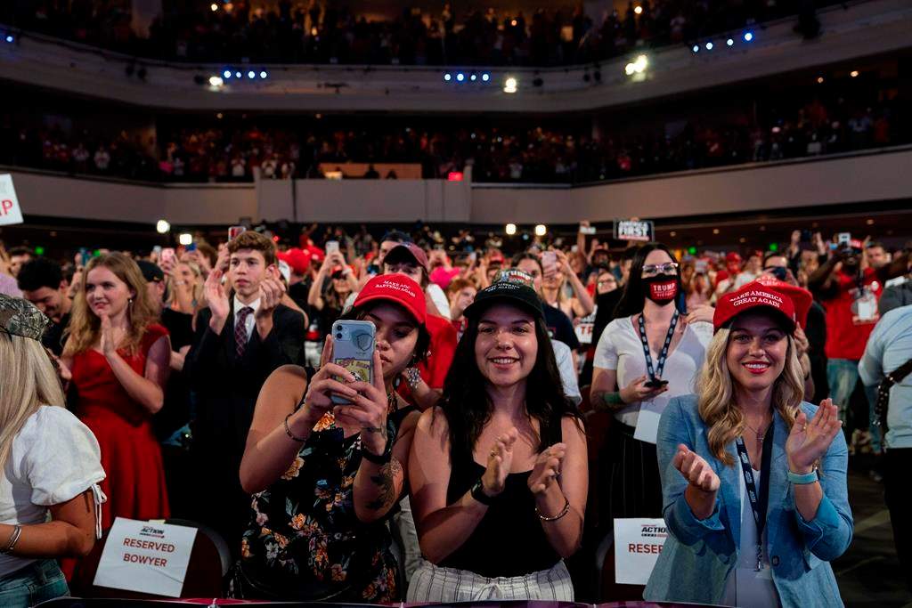 Supporters of President Donald Trump cheer as he arrives to a group of young Republicans at Dream City Church, Tuesday, June 23, 2020, in Phoenix.