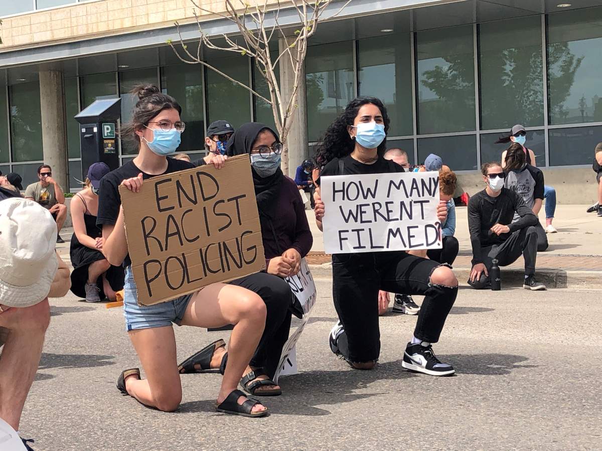 Demonstrators in the Saskatoon Black Lives Matter solidarity march take a knee outside of the police headquarters to honour George Floyd.