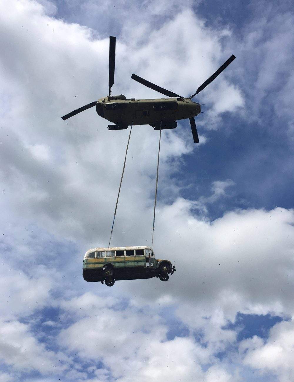 An Alaska Army National Guard CH-47 Chinook helicopter carries the bus made famous by the “Into the Wild” book and movie during its relocation near Stampede Trail west of Healy, Alaska, U.S. June 18, 2020.