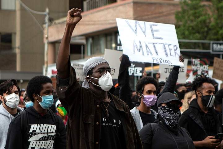 Demonstrators take part in a rally protesting the death of Regis Korchinski-Paquet in downtown Toronto, Saturday May 30, 2020. Korchinski-Paquet, 29, fell from the balcony of a 24th-floor Toronto apartment while police were in the home. Thousands of protesters took to the streets to rally in the aftermath of high-profile, police-involved deaths in both Canada and the United States. THE CANADIAN PRESS/Chris Young.