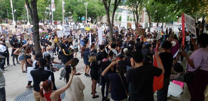 Protesters calling for racial equality and an end to police brutality arrive at Sir Winston Churchill Square in Edmonton on Friday night.