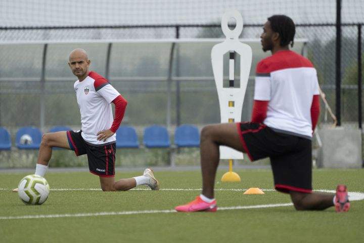 Atletico Ottawa midfielder Francisco Acuna and defender Vashon Neufville stretch during Atletico Ottawa’s first team practice of their inaugural season in the Canadian Premier League (CPL) in Ottawa, Wednesday June 3, 2020. 