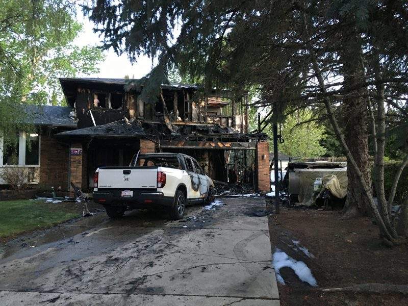 Extensive damage is visible after a fire engulfed a house in the 5900 block of Dalcastle Drive Northwest in Calgary, Alta., on Thursday, June 4, 2020.