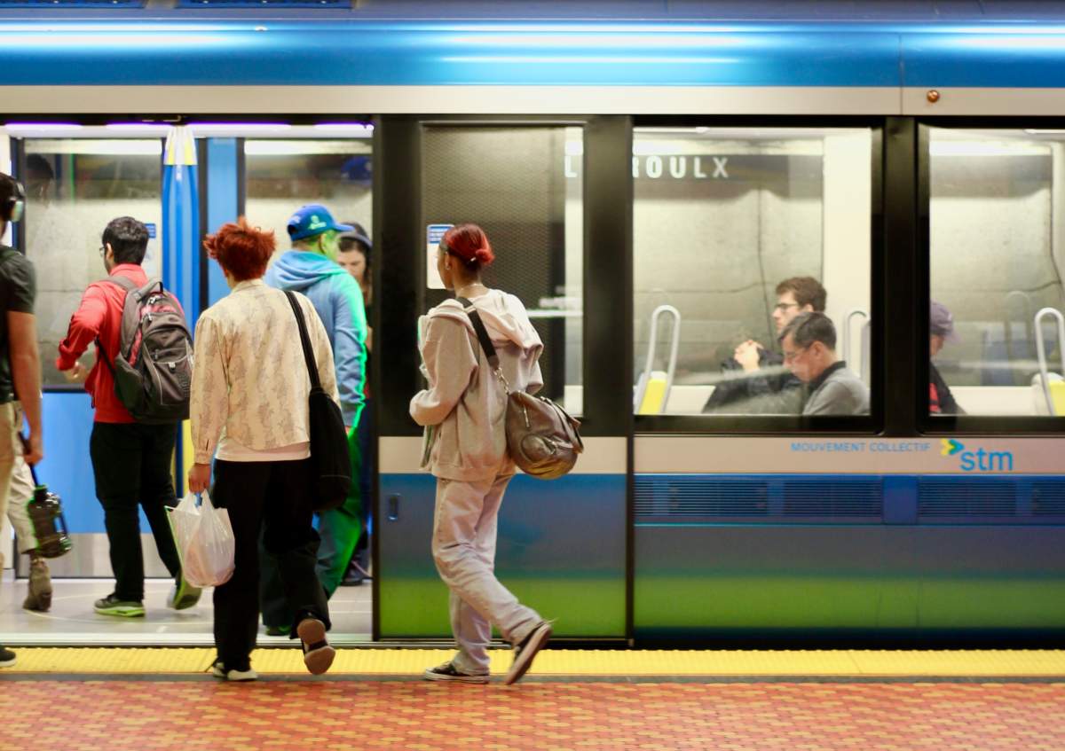 Passengers board a train on the Montreal metro at Lionel-Groulx station in the city's Sud-Ouest borough.