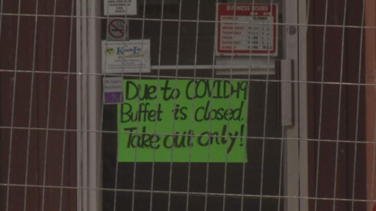 A coronavirus pandemic-related sign on a business in downtown Lindsay, Ont.