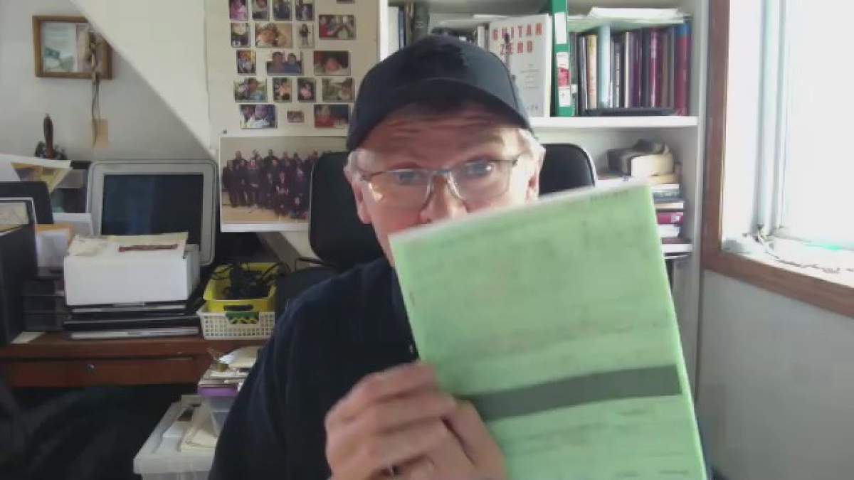 Rick Laliberte holds up a copy of the now-waived $2,800 ticket that had been issued to his son for trying to pass a provincial checkpoint to go south to get groceries on May 1.