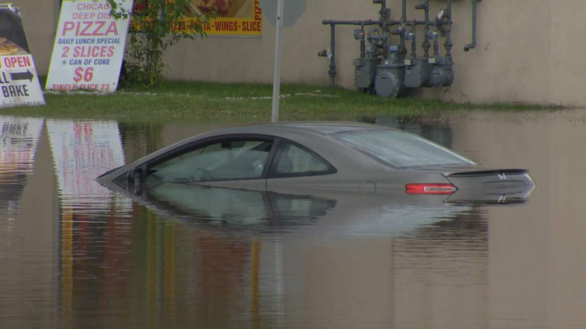 Car is submerged in water following a violent storm in Calgary over the weekend.