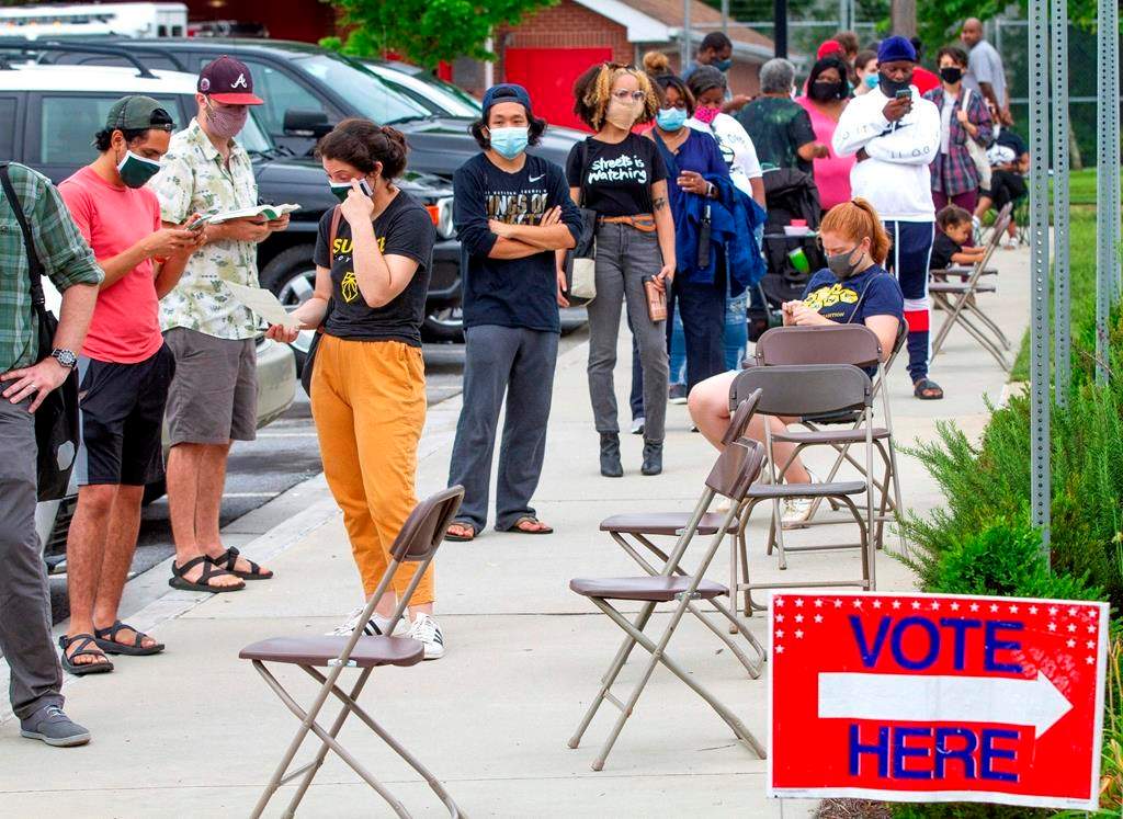 Voters wait in a line that stretched around the Metropolitan Library in Atlanta, Georgia, June 9, 2020.