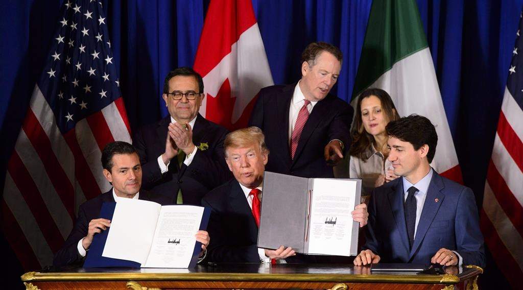 Prime Minister Justin Trudeau, right to left, Foreign Affairs Minister Chrystia Freeland, United States Trade Representative Robert Lighthizer, President of the United States Donald Trump, Mexico's Secretary of Economy Ildefonso Guajardo Villarreal, and Mexican President Enrique Pena Nieto participate in a signing ceremony for the new United States-Mexico-Canada Agreement in Buenos Aires, Argentina, Friday, Nov. 30, 2018.