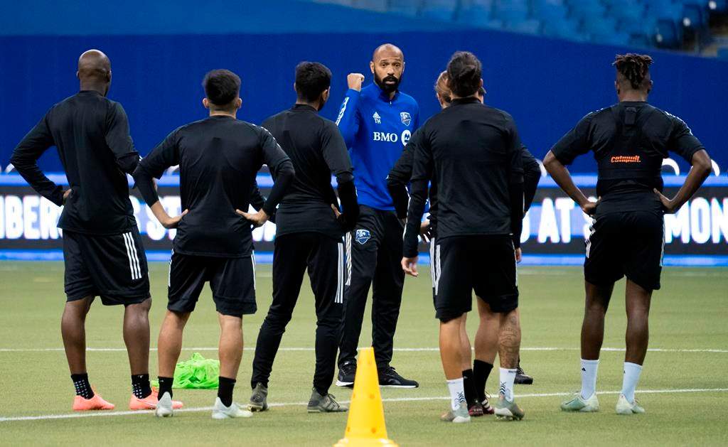 In this March 2020 file photo, players listen to Montreal Impact head coach Thierry Henry during a practice in Montreal.