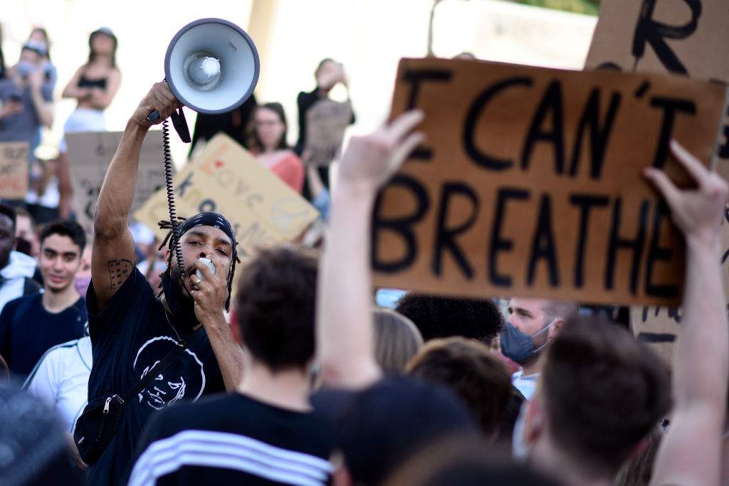 VIENNA, AUSTRIA - JUNE 04: A protester uses a megaphone during a Black Lives Matter march on June 04, 2020 in Vienna, Austria. The death of an African-American man, George Floyd, while in the custody of Minneapolis police has sparked protests across the United States, as well as demonstrations of solidarity in many countries around the world.  