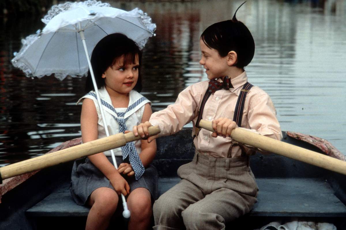 Bug Hall rowing a boat while looking at Brittany Ashton Holmes in a scene from the film ‘The Little Rascals’, 1994. (Photo by Universal Pictures/Getty Images)