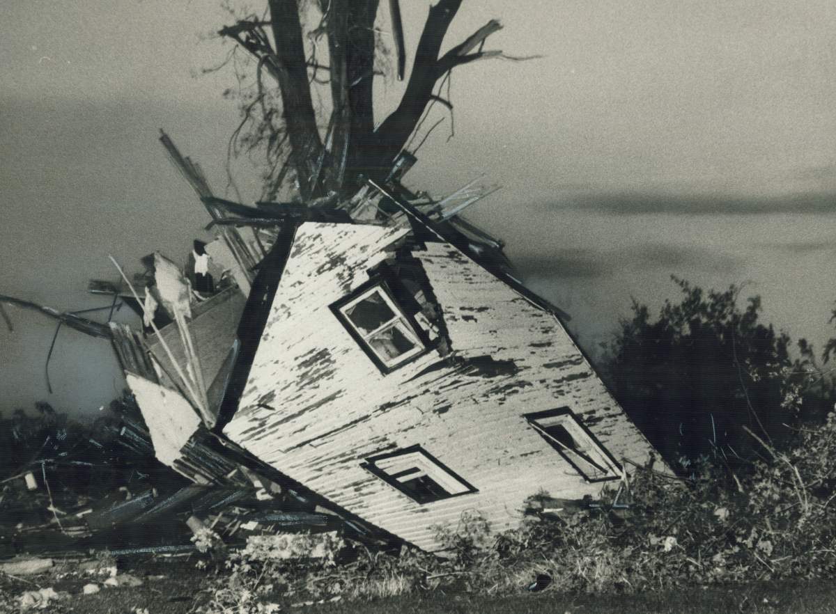 Original caption, August 1979: “Collapsed farmhouse leans against tree in Southwestern Ontario village of Vanessa; flattened by a violent tornado.”