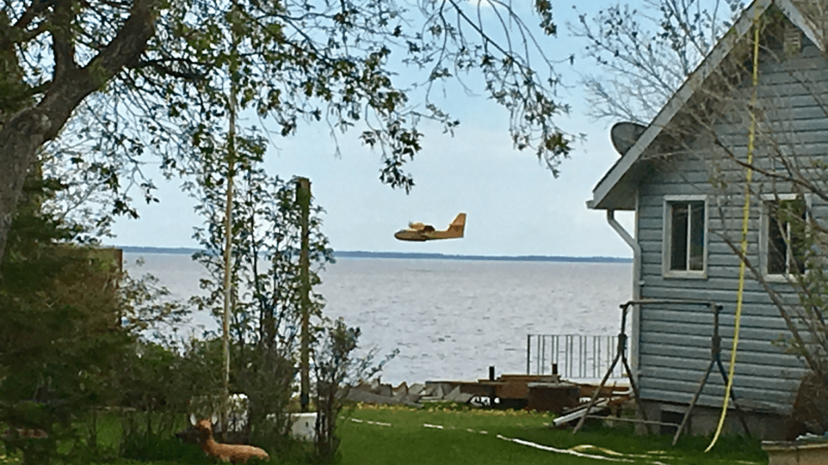 Water bombers work at a wildfire near Beaver Creek Provincial Park.