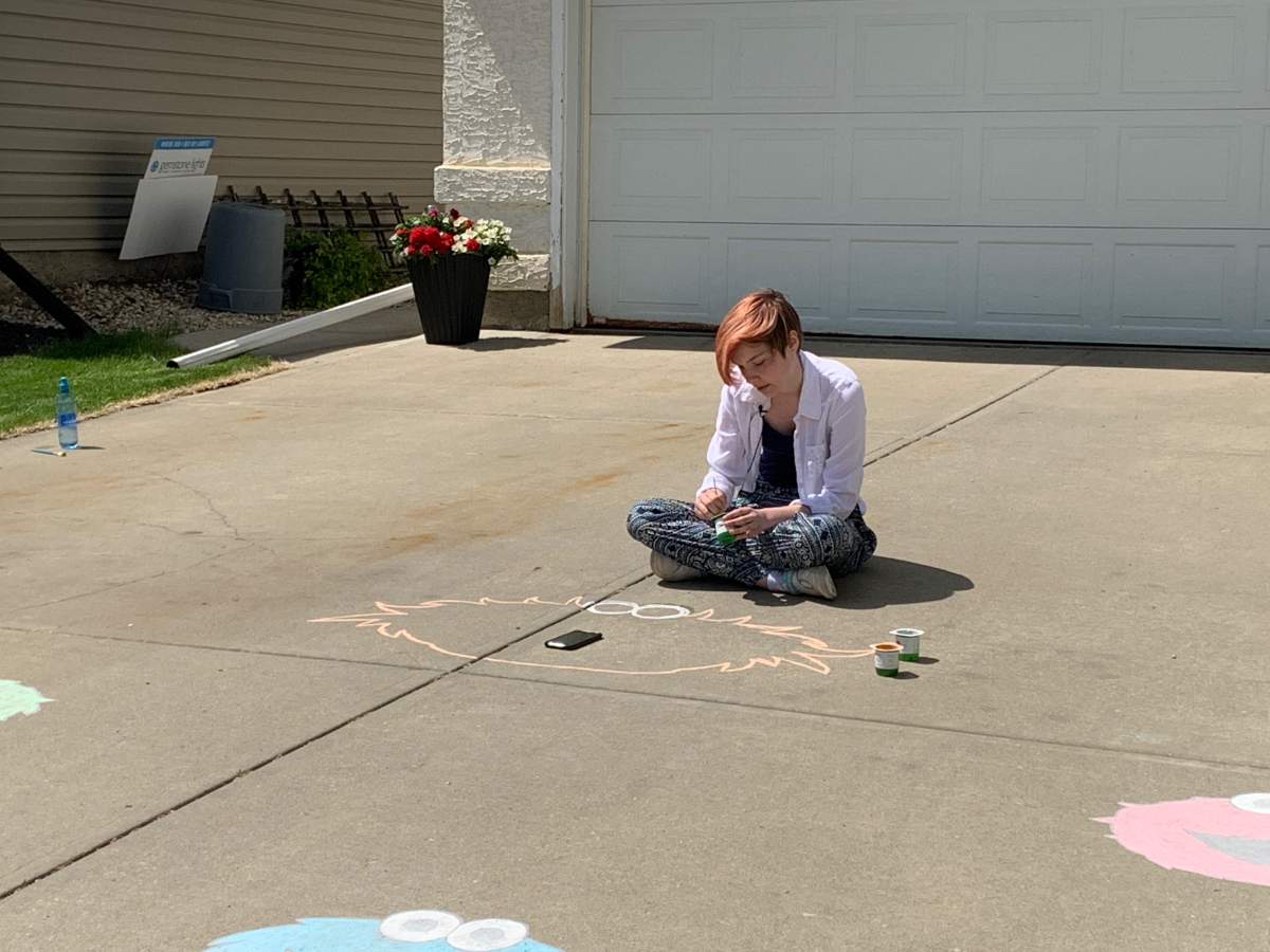 Paige Reid working on her chalk art on June 4, 2020