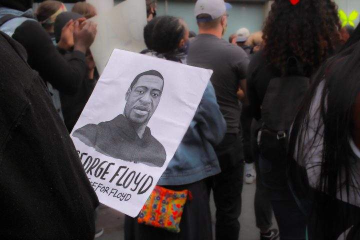 Woman holds a George Floyd poster at the Halifax rally in solidarity of the Black Lives Matter movement and victims of police brutality June 1. Winnipeg's mayor and the chiefs of the city's police and the fire department spoke about the city's response Tuesday.