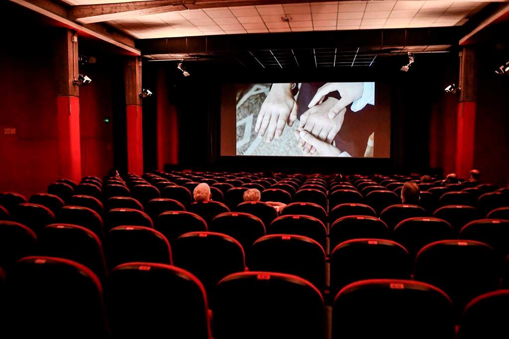 People sit in a cinema in Milan, Italy, Monday, June 15, 2020.