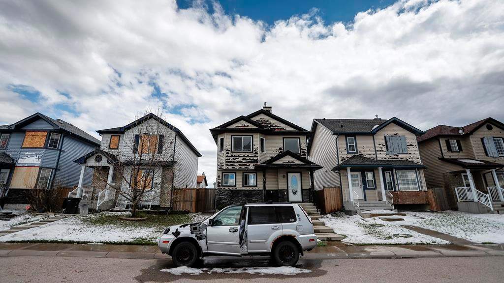 Residents survey the damage before begining cleanup in Calgary, Alta., Sunday, June 14, 2020, after a major hail storm damaged homes and flooded streets on Saturday.THE CANADIAN PRESS/Jeff McIntosh