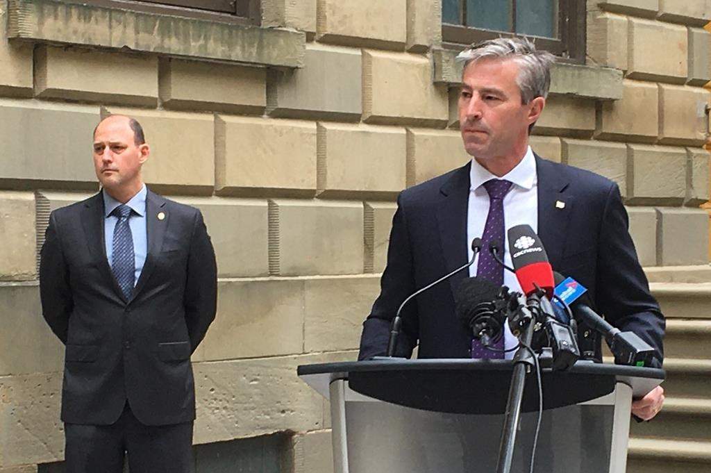 Nova Scotia Progressive Conservative Leader Tim Houston takes questions from reporters, Wednesday, June 24, 2020 outside the provincial legislature in Halifax.
