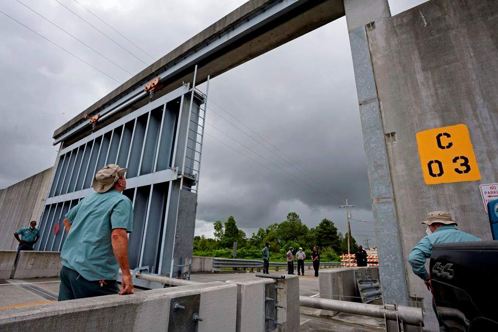 Crews from the Southeast Louisiana Flood Protection Authority East close the Bayou Road flood gate in St. Bernard Parish, La. Saturday, June 6, 2020, ahead of Tropical Storm Cristobal. A re-energized Tropical Storm Cristobal advanced toward the U.S. Gulf Coast early Saturday, bringing with it the heavy rains that already caused flooding and mudslides in Mexico and Central America. (Max Becherer/The Times-Picayune/The New Orleans Advocate)