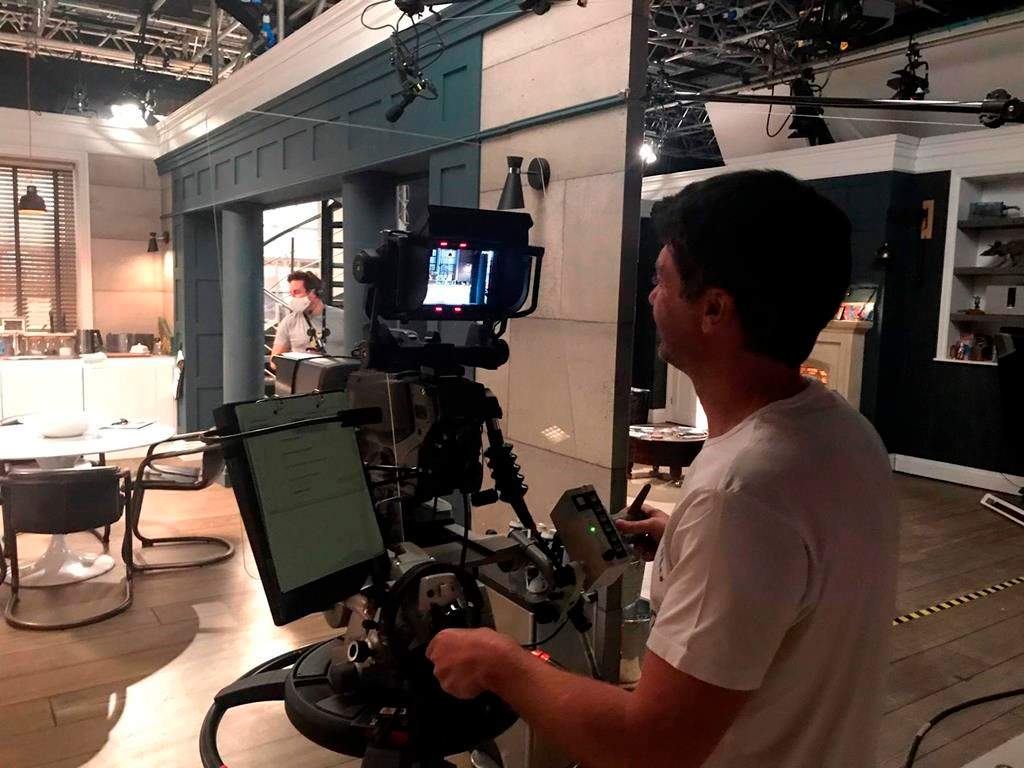 In this photo made available Wednesday June 10, 2020 by ITV/Emmerdale, reduced production staff film a scene on the set of the television show 'Emmerdale' in Leeds, England.