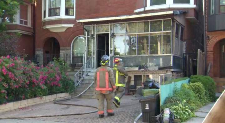Photo of firefighters on scene after a fire broke out at a home on Manning Avenue in Toronto.