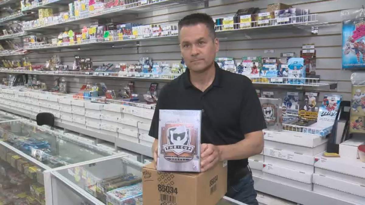 Wayne Wagner, owner of Wayne’s Sports Cards, with a pack of Upper Deck The Cup cards on June 17, 2020.