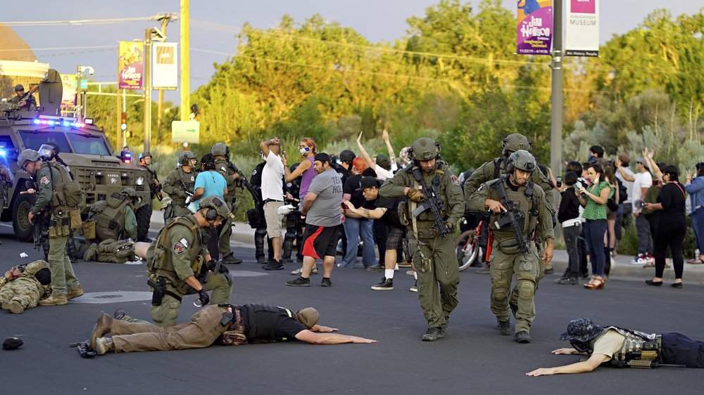 Albuquerque police detain members of the New Mexico Civil Guard, an armed civilian group, Monday, June 15, 2020, in Albuquerque, N.M.