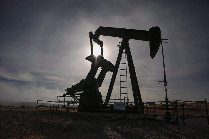 A pumpjack works at a well head on an oil and gas installation near Cremona, Alta., on October 29, 2016. 