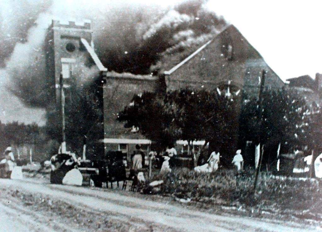 FILE – In this 1921 file image provided by the Greenwood Cultural Center via Tulsa World, Mt. Zion Baptist Church burns after being torched by white mobs during the 1921 Tulsa massacre. Black community and political leaders called on President Donald Trump to at least change the Juneteenth date for a rally kicking off his return to public campaigning, saying Thursday, June 11, 2020. From Sen. Kamala Harris of California to Tulsa civic officials, black leaders said it was offensive for Trump to pick that date — June 19 — and that place — Tulsa, an Oklahoma city that in 1921 was the site of a fiery and orchestrated white-on-black killing spree. (Greenwood Cultural Center via Tulsa World via AP)