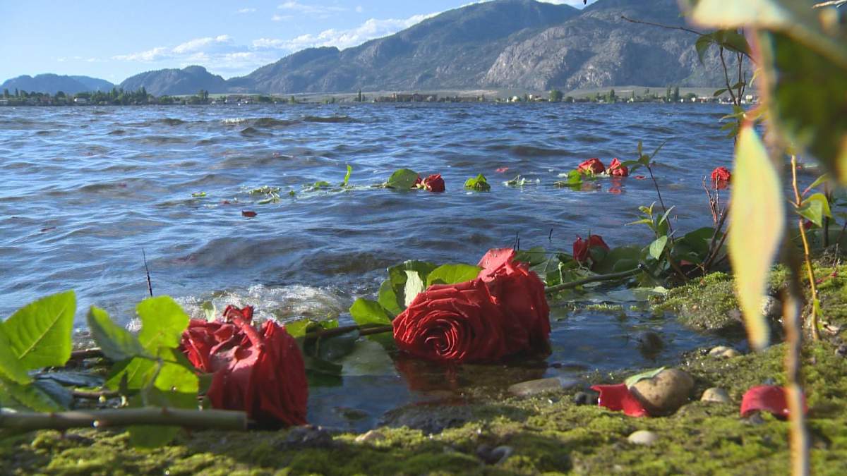 Family and friends put roses into the water in memory of Nicholas Trask.