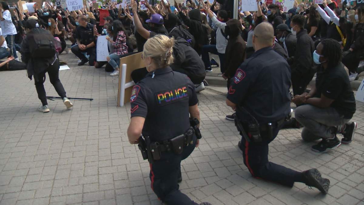 Calgary police take a knee in solidarity with Black Lives Matter protesters on Monday, June 1, 2020.