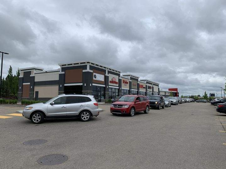 Cars line up outside a west Edmonton Popeyes restaurant on June 17, 2020.