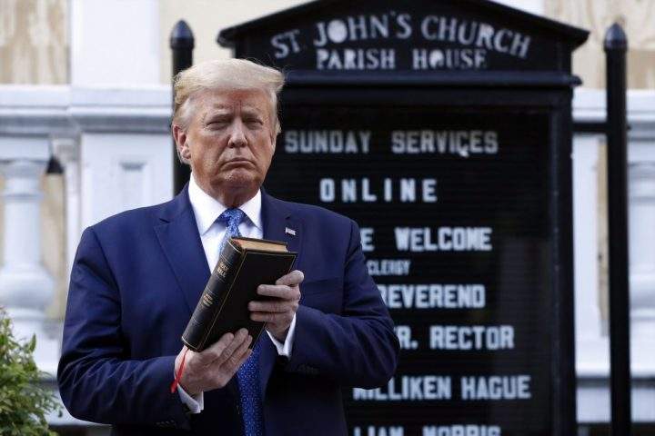 President Donald Trump holds a Bible as he visits outside St. John’s Church across Lafayette Park from the White House Monday, June 1, 2020, in Washington. Part of the church was set on fire during protests on Sunday night.