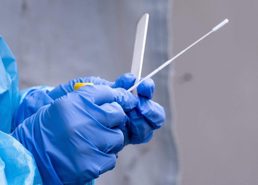 A nurse gets a swab ready at a temporary COVID-19 test clinic in Montreal, on Friday, May 15, 2020.