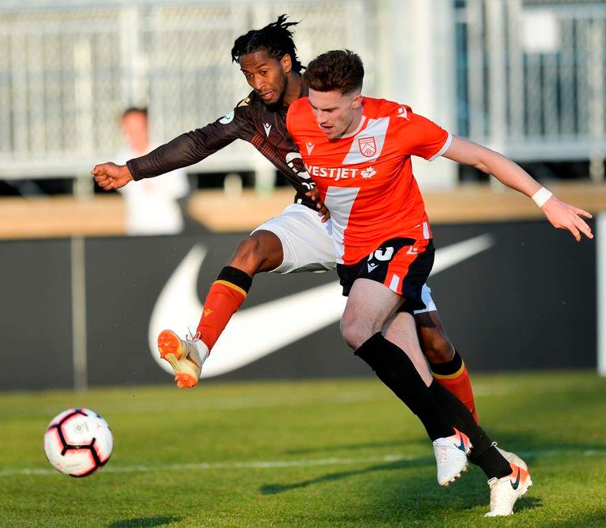 Ali Musse of Valour FC (left) and Joel Waterman of Cavalry FC vie for the ball during CPL action in Calgary, May 8, 2019. It looks like Prince Edward Island will lead the way in Canada's return to soccer, with the Canadian Premier League possibly looking to finally kick off its season in Charlottetown. 