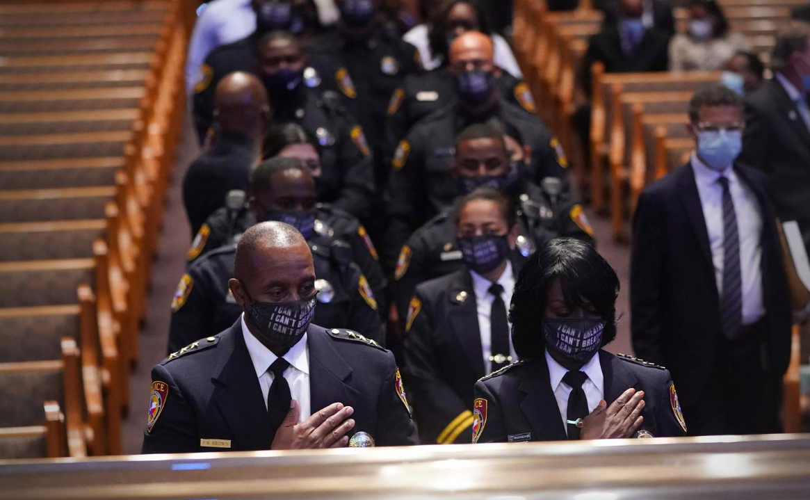 Members of the Texas Southern University police department pause during a funeral service for George Floyd at The Fountain of Praise church Tuesday, June 9, 2020, in Houston.