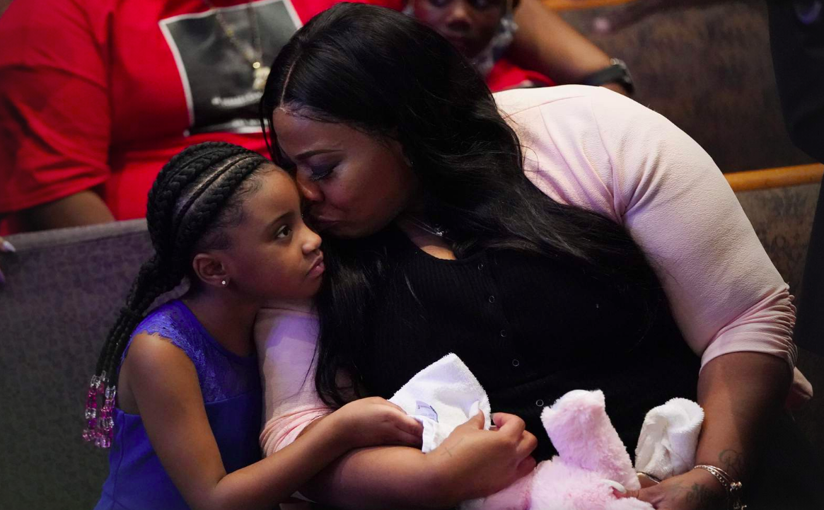 Roxie Washington holds Gianna Floyd, the daughter of George Floyd as they attend the funeral service for George Floyd at The Fountain of Praise church Tuesday, June 9, 2020, in Houston.
