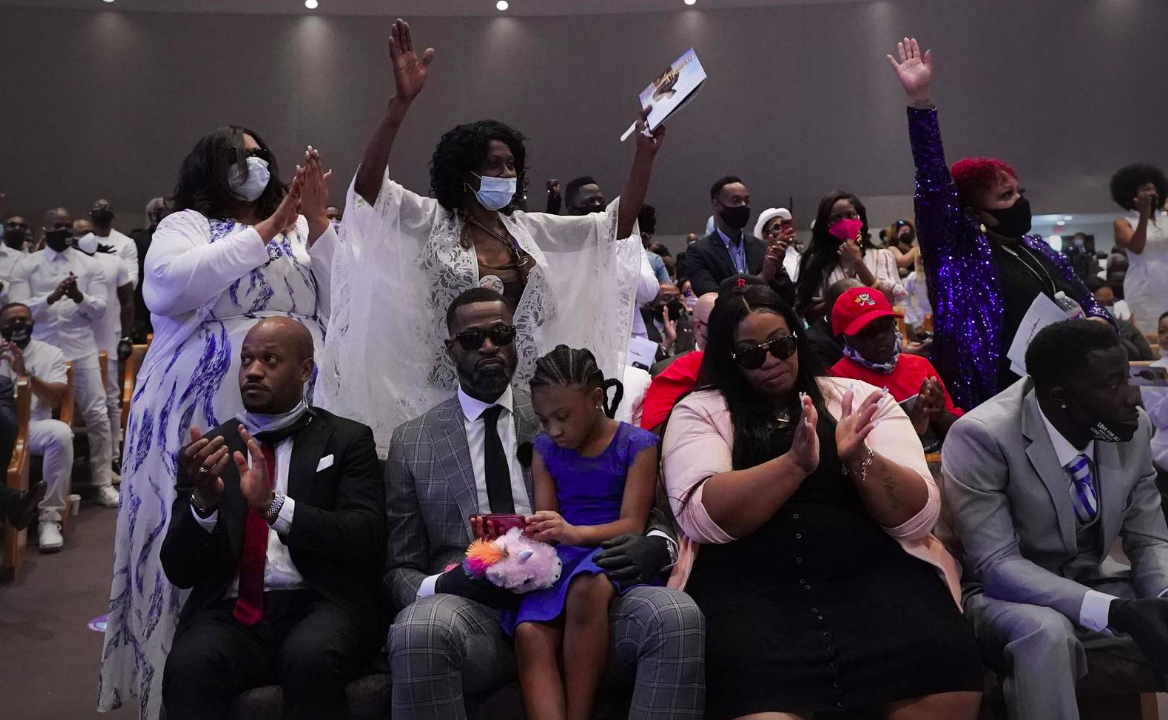 Sister of George Floyd, Zsa Zsa Floyd, both arms raised, attend the funeral service for Floyd at The Fountain of Praise church Tuesday, June 9, 2020, in Houston.