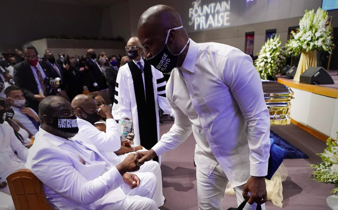 Actor Jamie Foxx, right, speaks with Rodney Floyd during the funeral service for George Floyd at The Fountain of Praise church Tuesday, June 9, 2020, in Houston.