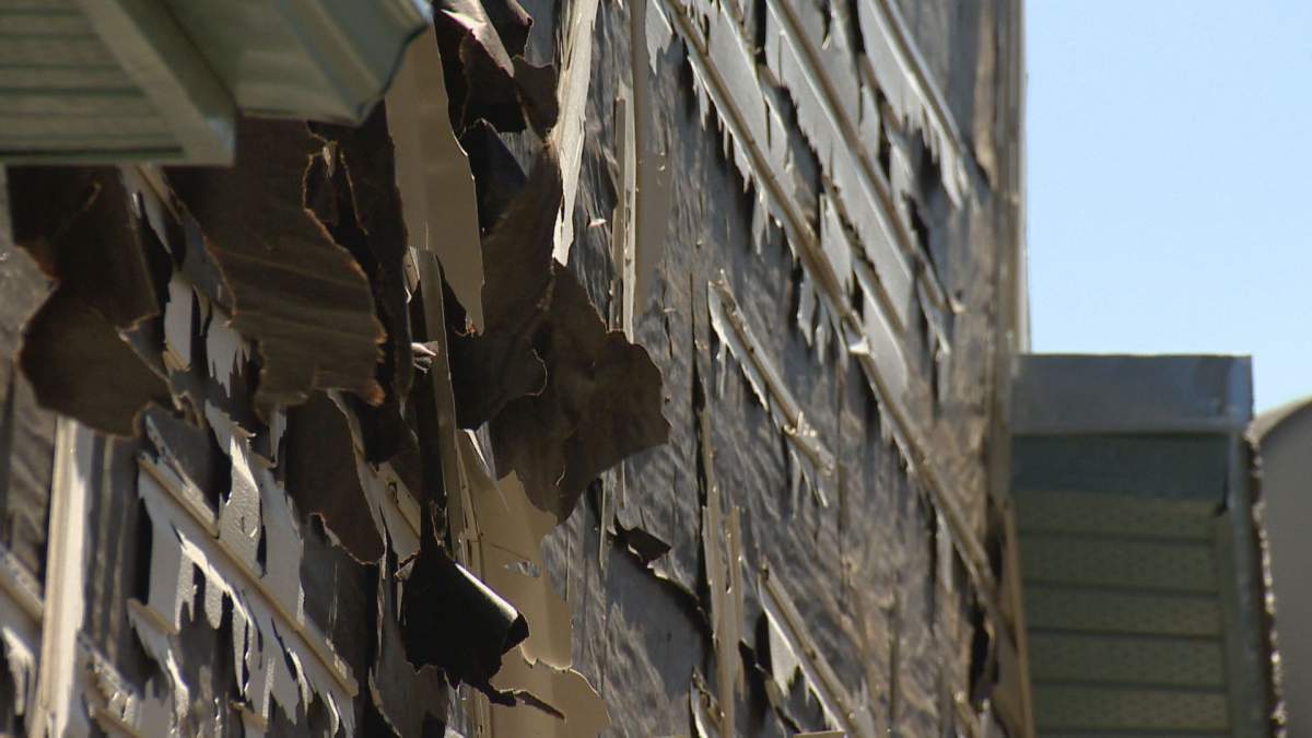 The siding on a Calgary home is in tatters following a violent storm