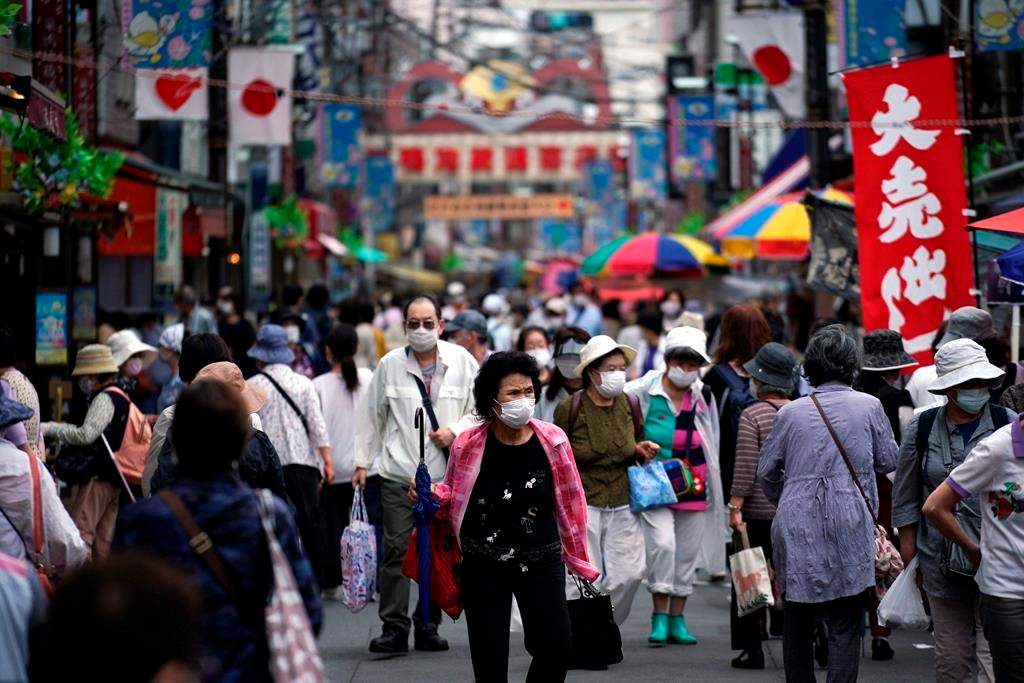 A street is crowded by shoppers in Tokyo Wednesday, June 24, 2020. Japan’s economy is opening cautiously, with social-distancing restrictions amid the coronavirus pandemic.