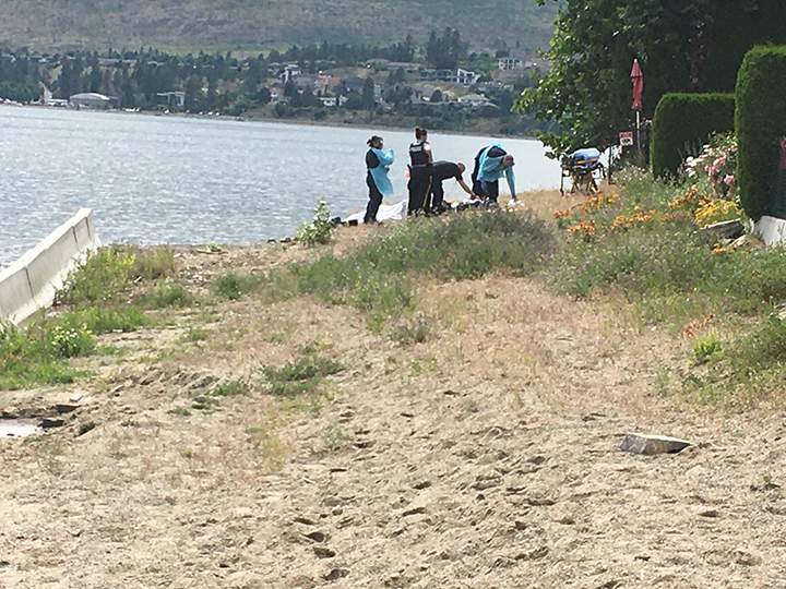 Emergency crews on the beach of Okanagan Lake.