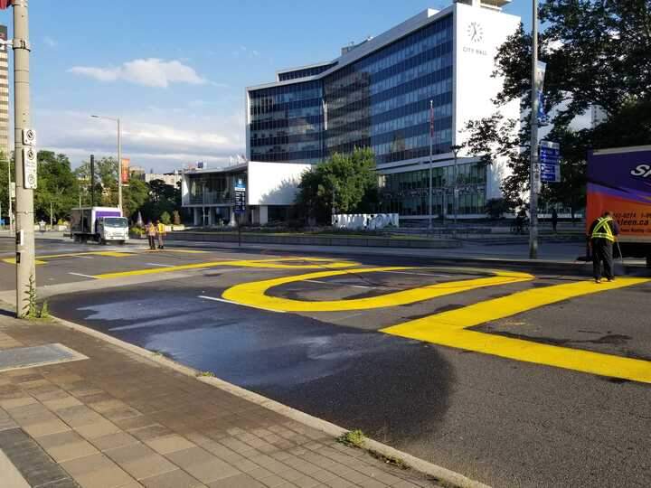 Demonstrators painted the phrase 'DEFUND THE POLICE' outside Hamilton City Hall. 
